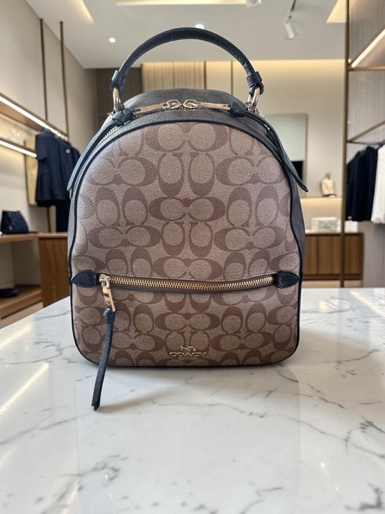coach backpack monogram Brown Signature & Black Leather Signature coated canvas and smooth leather Inside zip cell phone and multifunction pockets Laptop compartment with zip closure Zip closure recycled polyester lining Top handle with 3 drop Outside zip pocket Luggage sleeve Adjustable shoulder straps Fits a 16 laptop 11 3/4 (L) x 16 1/2 (H) x 6 (W) Style No. Charter Backpack in Signature Jacquard